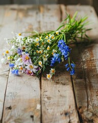 A handpicked bouquet of wildflowers lays upon a rustic wooden table. Wildflowers bouquet on rustic wood. Handpicked bouquet of field flowers with natural charm.