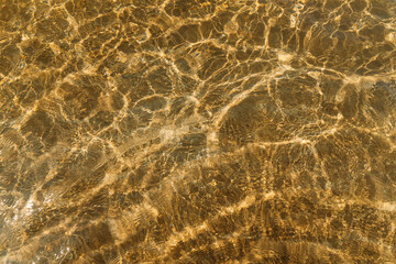beige sand contrasts with the ocean, making it a work of art in nature. concept for perfumes, smells, heat, freshness, coolness and other associations. Ripple sea ocean water surface with small waves - 751384568