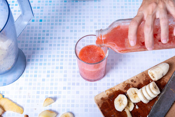 Serving a healthy homemade fruit smoothie.