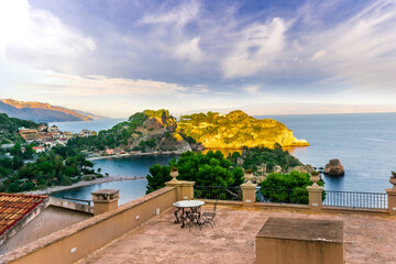 panoramic view from a hotel balcony with terrace to a beautiful sea gulf with sceniv isle and mountains with cloudy sky on background - obrazy, fototapety, plakaty