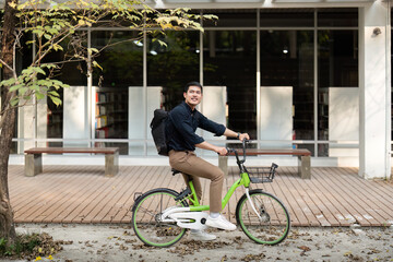Eco friendly, Happy lifestyle asian young businessman ride bicycle go to office work at city street with bicycle in morning