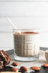 Glass with protein drink, healthy milkshake smoothie on wooden board
