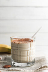Glass with protein drink, healthy milkshake smoothie on white table