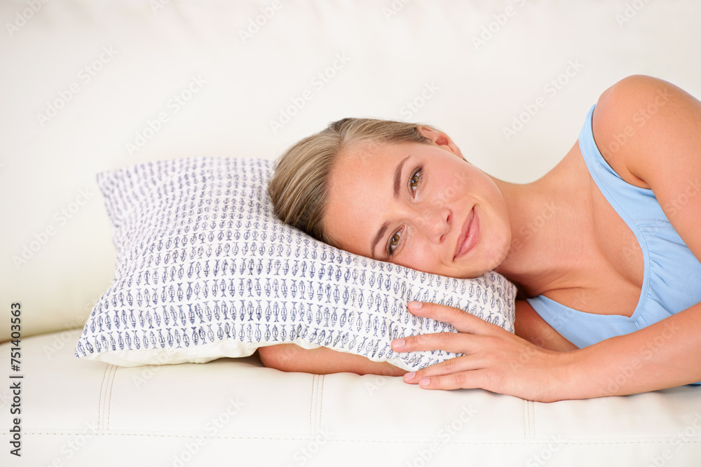 Wall mural Portrait, woman and laying on couch with pillow to relax, lounge at home in apartment. Smiling, happy female person resting on weekend, Sunday break in free time on holiday on comfortable vacation