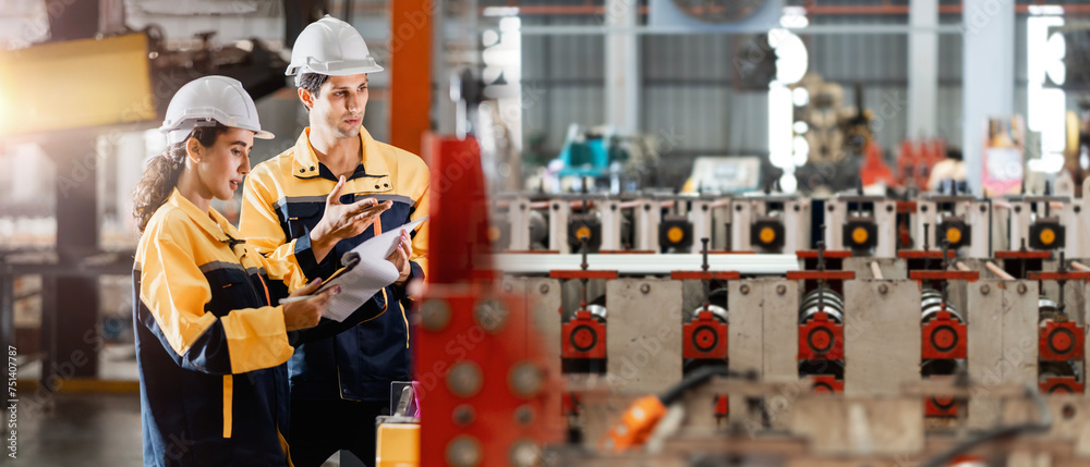 Wall mural two professional engineer,worker,technician use clipboard discuss work, walk in steel metal manufact