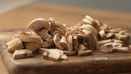 Chopping Mushrooms on Wooden Surface. Close-up, shallow dof.