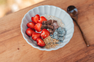 Healthy oatmeal with strawberry and chocolate topping