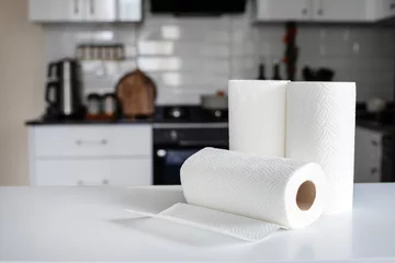 Fotobehang Rolls of paper towels on white marble table in kitchen © Hazal