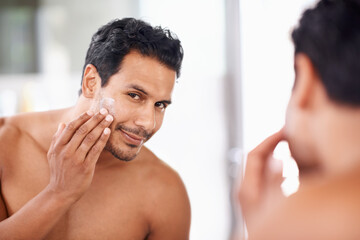 Skincare, mirror and cream with man in bathroom for morning routine, facial treatment and...