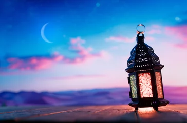Tuinposter Arabic lantern with burning candle © Konstantin Yuganov