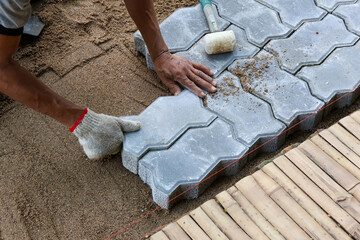 selective focus Interlocking Paver Tile modern bricks are meticulously prepared on the floor by...