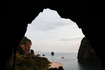 View looking out of cave at islands