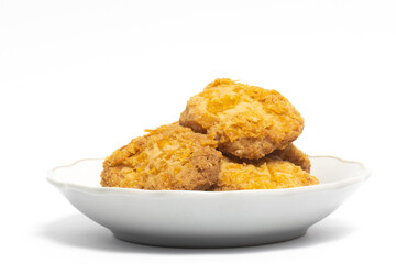 Cornflakes cookies in a small white plate isolated on white background clipping path
