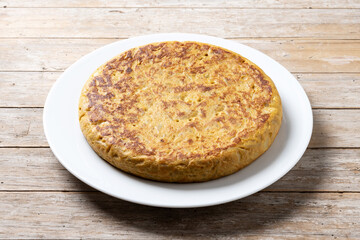 Traditional spanish omelette on wooden table.