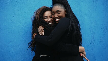 African American Adolescent daughter hugs mother in genuine affectionate love. Caring moment...