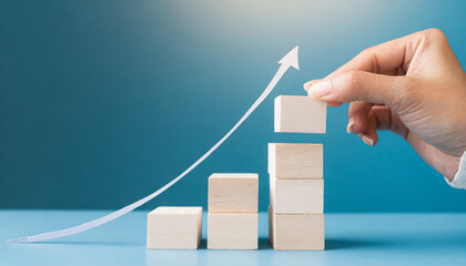 Business concept growth success process, Close up man hand arranging wood block stacking as step stair on paper blue background, copy space.