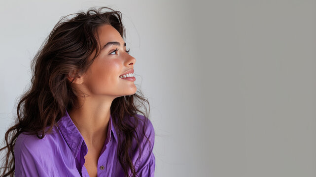 Hispanic woman wearing purple shirt smile looking up isolated on gray