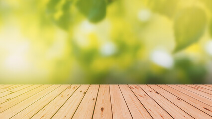 Wood floor with blurred trees of nature park background and summer season. Product display template.