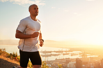 Fitness, running and man on hill at sunset for health, wellness and strong body development. Workout, exercise and runner on path in nature for marathon training, performance and outdoor challenge. - obrazy, fototapety, plakaty
