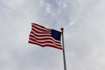 The United States flag blowing in the wind.