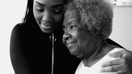 Caring African American Teenager Tenderly Holding Elderly Grandmother with Gray Hair, Celebrating...