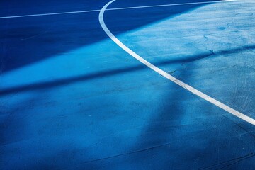 A blue and white basketball court with a white line