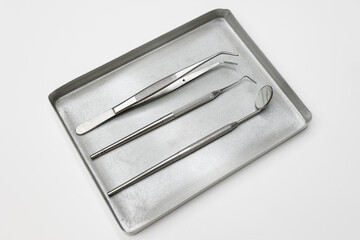 Dental instruments, forceps close up ,set of tools isolated on white, set of metal dental instruments. Dental extraction forceps.