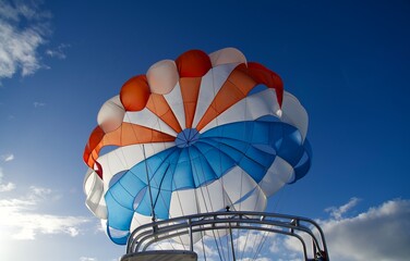 Parasailing in Hawaii on a blue sky day