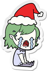 sticker cartoon of a crying vampire girl wearing santa hat