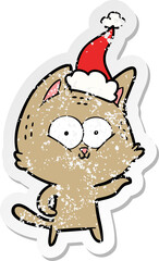 distressed sticker cartoon of a cat wearing santa hat
