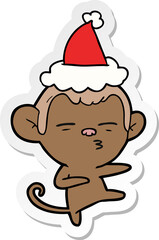 sticker cartoon of a suspicious monkey wearing santa hat