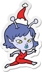 pretty sticker cartoon of a alien girl running wearing santa hat