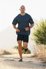 Fitness, running and man on path in mountain for health, wellness and strong body development....