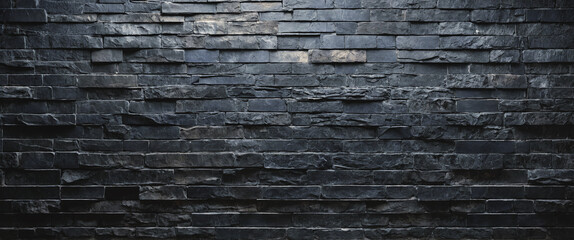 Background and texture of black blue stone brick with light illuminated in places. Panorama.