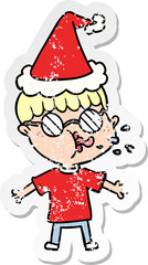 distressed sticker cartoon of a boy wearing spectacles wearing santa hat