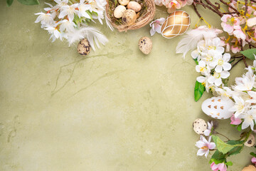 Easter eggs and nests with spring flora background. Easter light green flat lay with bird nests, eggs, and spring tree flowers, frame for festive greeting card copy space 
