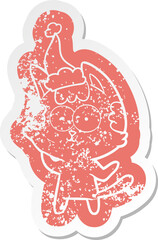 happy cartoon distressed sticker of a cat wearing santa hat