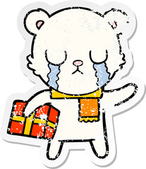 distressed sticker of a crying polar bear cartoon with christmas gift