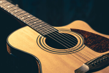 Musical background with acoustic guitar close up.