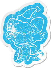 cute cartoon distressed sticker of a dog wearing santa hat