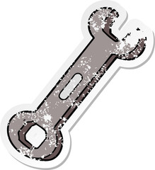 distressed sticker of a cartoon spanner