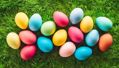 Fototapeta na wymiar colorful easter eggs on green grass top view