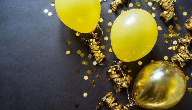 free photos gold yellow balloons and falling foil confetti on black background for writing space