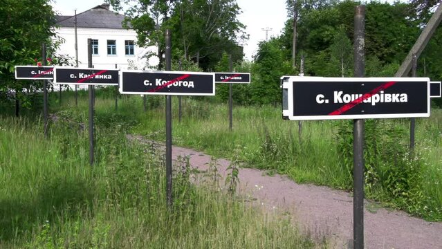 Black signs with the names of disappeared, destroyed villages in the Chernobyl exclusion zone. A lane of abandoned villages.
