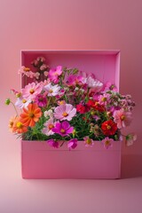 A charming open flower box brimming with a variety of vibrant flowers neatly arranged against a pink backdrop