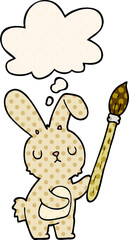 cartoon rabbit with paint brush and thought bubble in comic book style