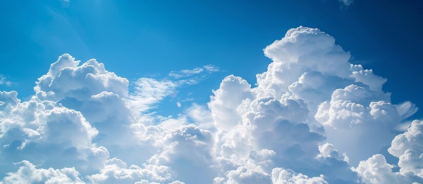 Commercial airplane flying high in the blue sky with fluffy white clouds on a sunny day