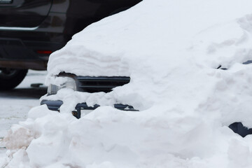 Frozen Reflections: Enveloped in Snow, a Car Braces Winters Embrace Beside a Stoic Parking Meter