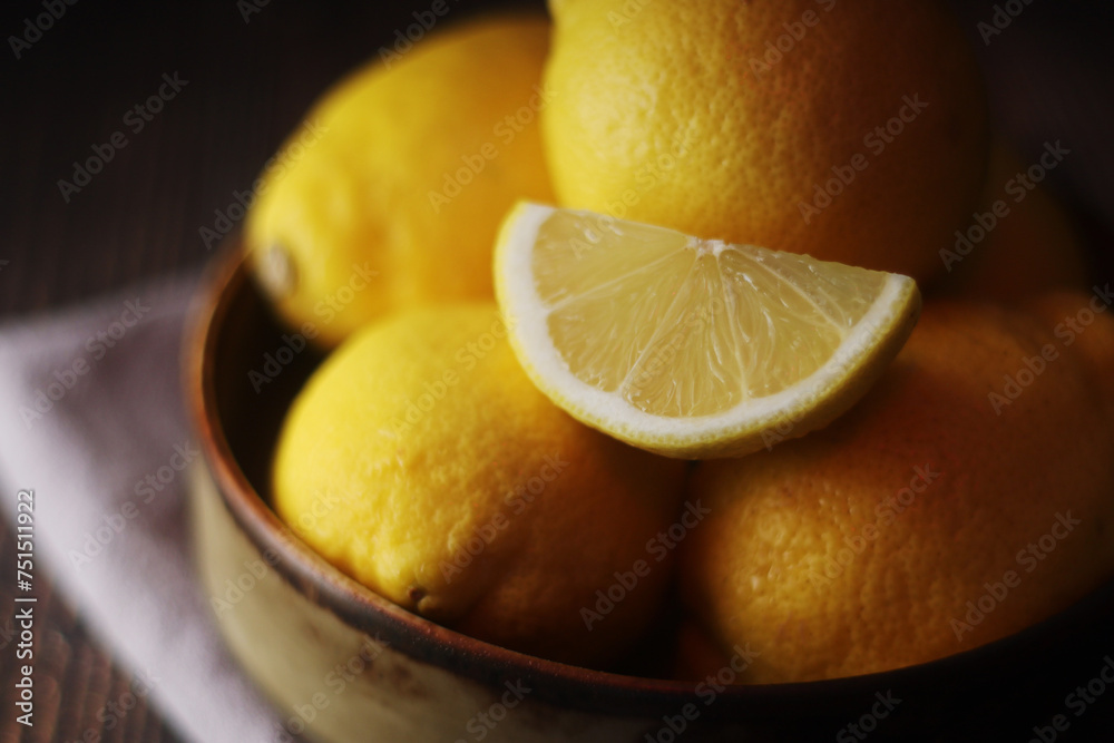 Wall mural A bowl with yellow bright lemons	