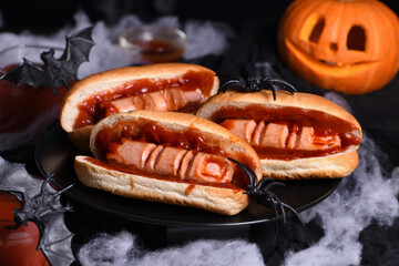 Plate of hot dogs Bloody fingers on a Halloween table